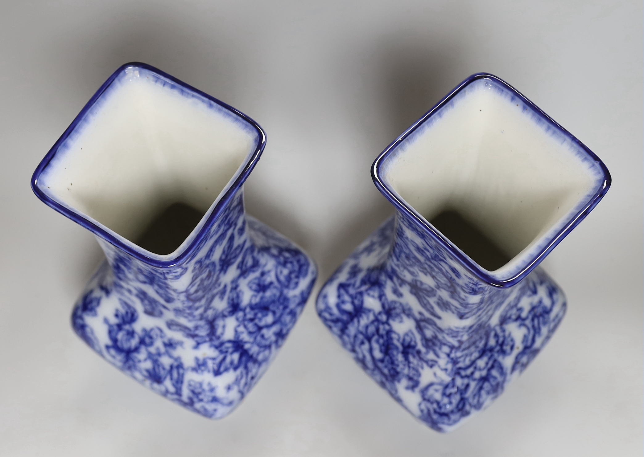 A pair of Losol ware blue and white vases, a slipware jug, a faience candle holder and a Chinese tea canister (without cover), vases 33cm high